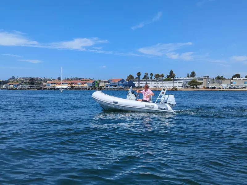 Slide: The Image of Tide Craft Nantucket 12 boat cruising on a sunny day, 2025 model. - 1