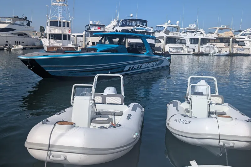 Slide: The Image of Two Tide Craft Nantucket 12-Hypalon boats docked in a marina, 2026 model. - 9