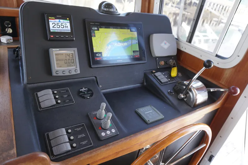 Slide: The Image of Control panel of a 2004 American Tug 34 with navigation and depth instruments. - 18
