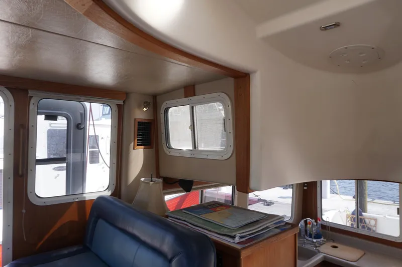 Slide: The Image of Interior of 2004 American Tug 34, featuring cozy seating and nautical decor. - 24