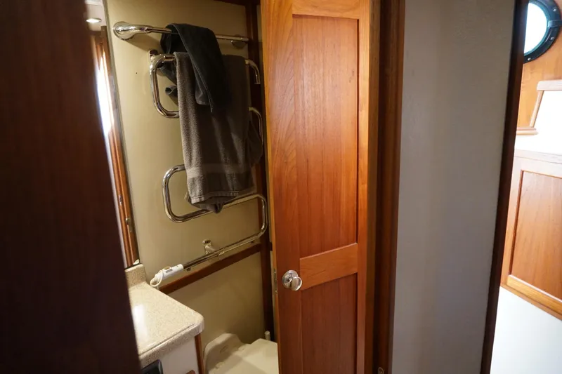 Slide: The Image of Bathroom interior of 2004 American Tug 34 with wooden door and towel rack. - 32
