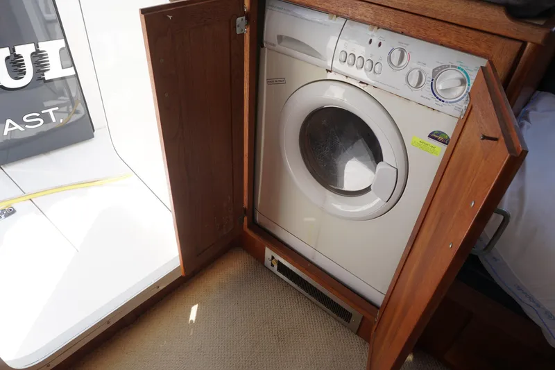 Slide: The Image of Washing machine inside a 2004 American Tug 34 boat's wooden cabinet. - 33