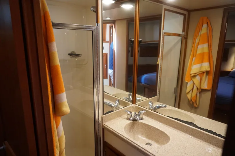 Slide: The Image of Bathroom interior of 2004 American Tug 34 with shower and striped towel. - 34