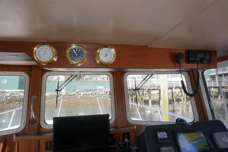 Slide: The Image of Pilothouse interior of 2004 American Tug 34 with navigation instruments and gauges. - 40