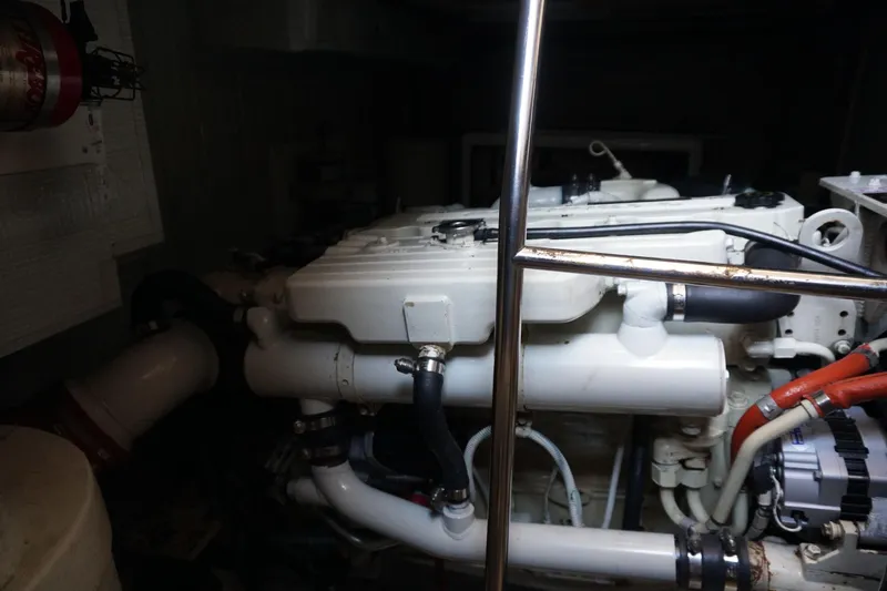 Slide: The Image of Engine room of a 2004 American Tug 34, showcasing mechanical components and piping. - 43