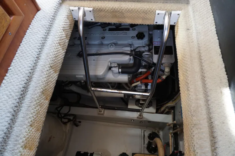 Slide: The Image of Engine compartment of a 2004 American Tug 34 with visible ladder and engine components. - 44
