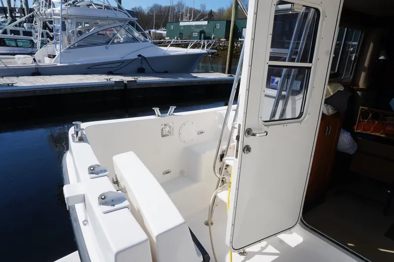Slide: The Image of 2004 American Tug 34 boat with open cabin door at marina dock. - 45