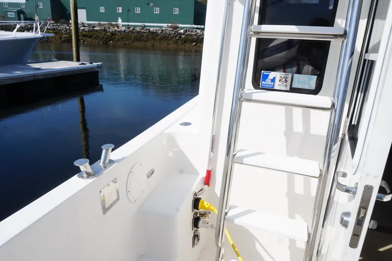 Slide: The Image of 2004 American Tug 34 boat deck with ladder and dock view. - 46