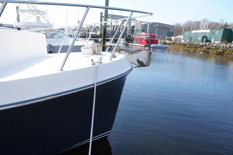Slide: The Image of 2004 American Tug 34 docked in a marina, showcasing its sleek bow design. - 52