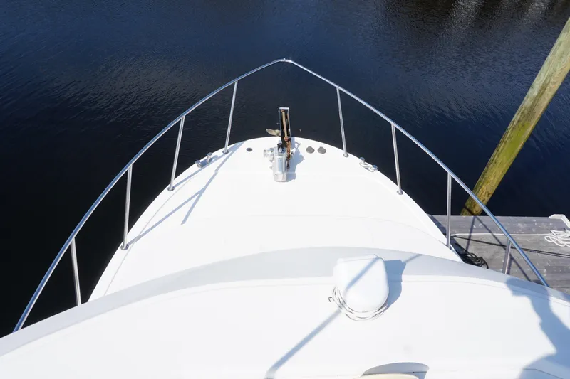 Slide: The Image of Bow view of 2004 American Tug 34 docked on calm water. - 58