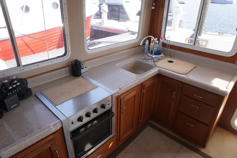 Slide: The Image of Galley kitchen in 2004 American Tug 34 with stove, sink, and ample counter space. - 6