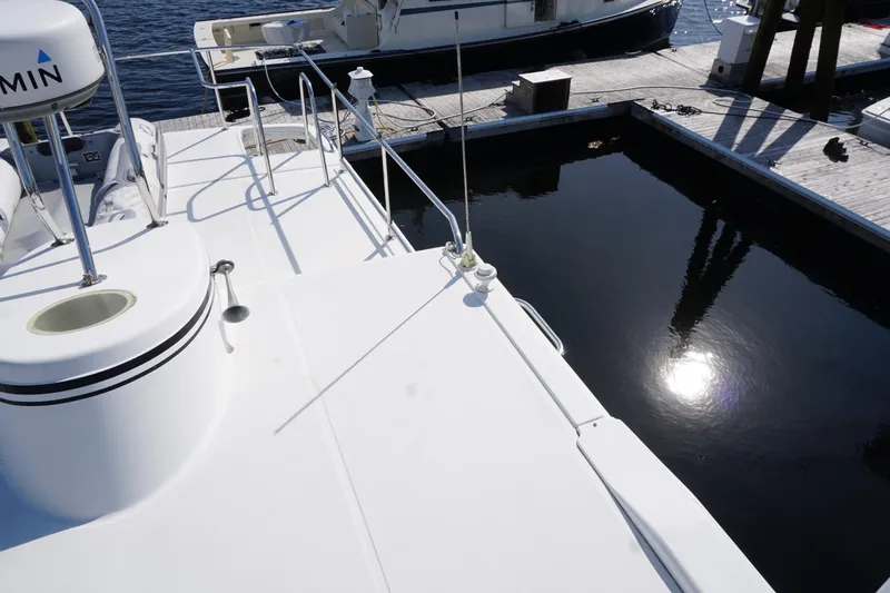 Slide: The Image of 2004 American Tug 34 docked, showcasing deck details and marina setting. - 60