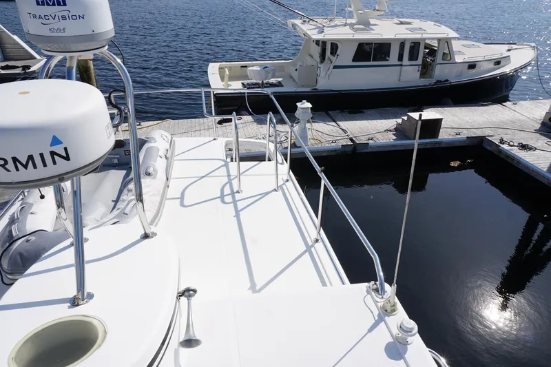 Slide: The Image of 2004 American Tug 34 docked, featuring Garmin and TracVision equipment. - 61