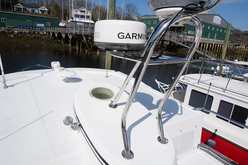 Slide: The Image of 2004 American Tug 34 boat with Garmin radar, docked at a marina. - 62