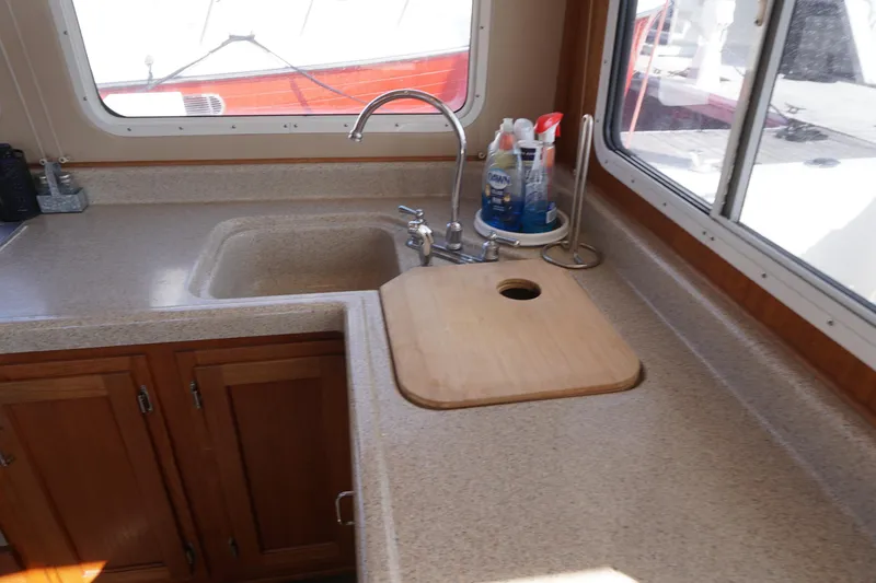 Slide: The Image of Kitchen area of a 2004 American Tug 34 with sink and countertop. - 9