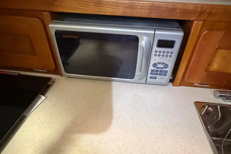 Slide: The Image of Microwave in 2007 Hunt Yachts Surfhunter 29 kitchen with wooden cabinetry. - 13
