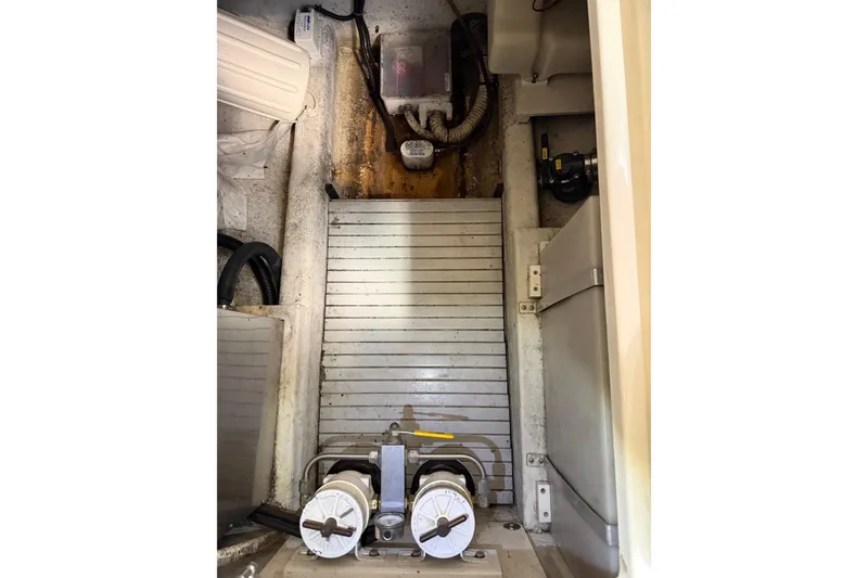 Slide: The Image of Engine compartment of 2007 Hunt Yachts Surfhunter 29, showcasing mechanical components and wiring. - 16