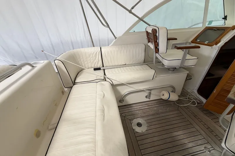Slide: The Image of 2007 Hunt Yachts Surfhunter 29 interior with white seating and wooden flooring. - 17