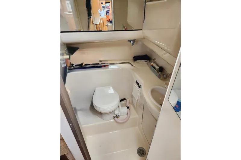 Slide: The Image of Compact bathroom in 2002 Bayliner 2655 Ciera Sunbridge boat, featuring toilet and sink. - 6