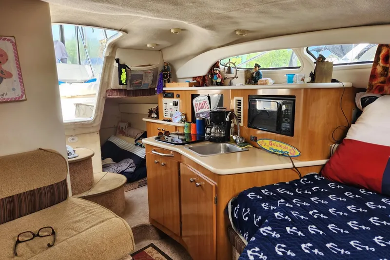Slide: The Image of Interior of 2002 Bayliner 2655 Ciera Sunbridge with kitchenette and cozy seating area. - 8
