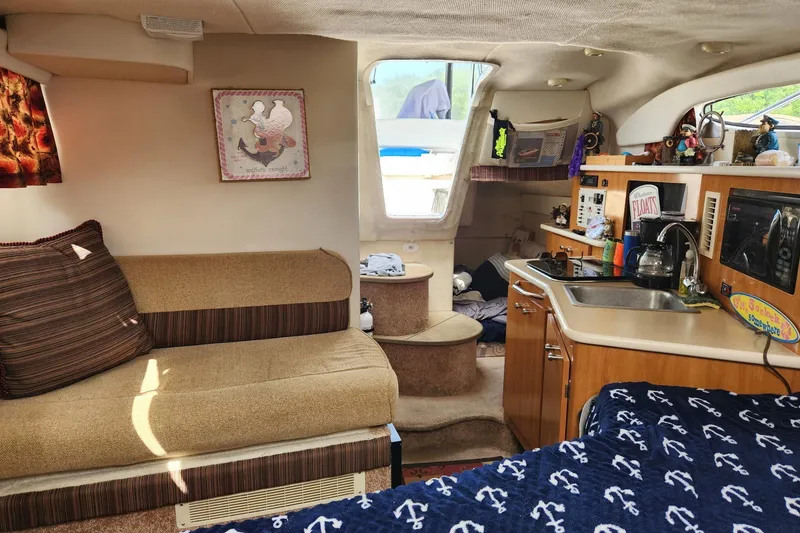 Slide: The Image of Interior of 2002 Bayliner 2655 Ciera Sunbridge with cozy seating and kitchenette. - 9