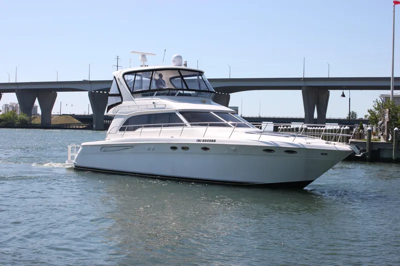 Slide: The Image of 2001 Sea Ray 480 Sedan Bridge yacht cruising near a bridge on a sunny day. - 15