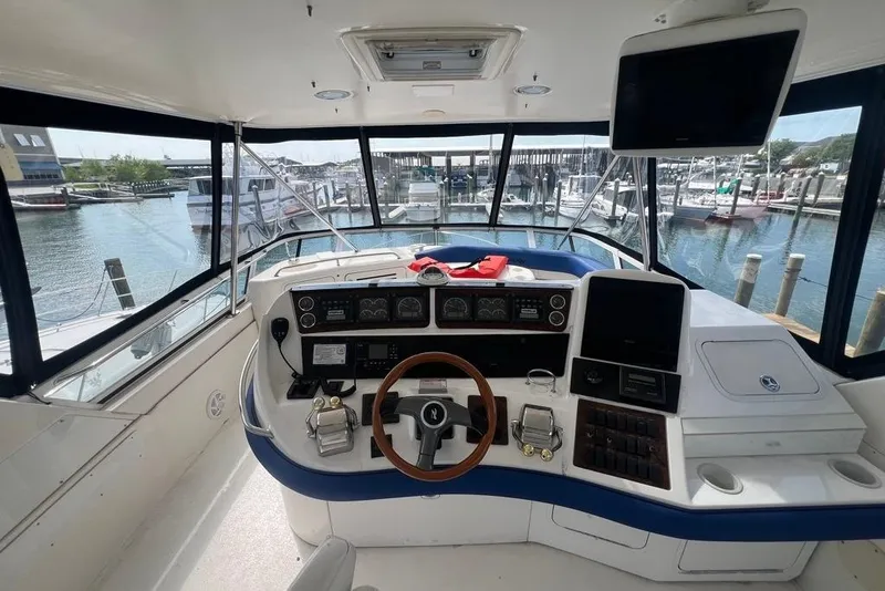Slide: The Image of Cockpit view of 2001 Sea Ray 480 Sedan Bridge yacht docked at marina. - 16