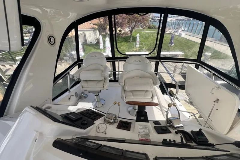 Slide: The Image of Interior view of 2001 Sea Ray 480 Sedan Bridge yacht cockpit with helm and seating. - 20