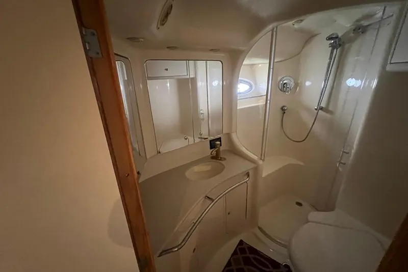 Slide: The Image of Bathroom interior of 2001 Sea Ray 480 Sedan Bridge yacht, featuring shower and sink. - 21