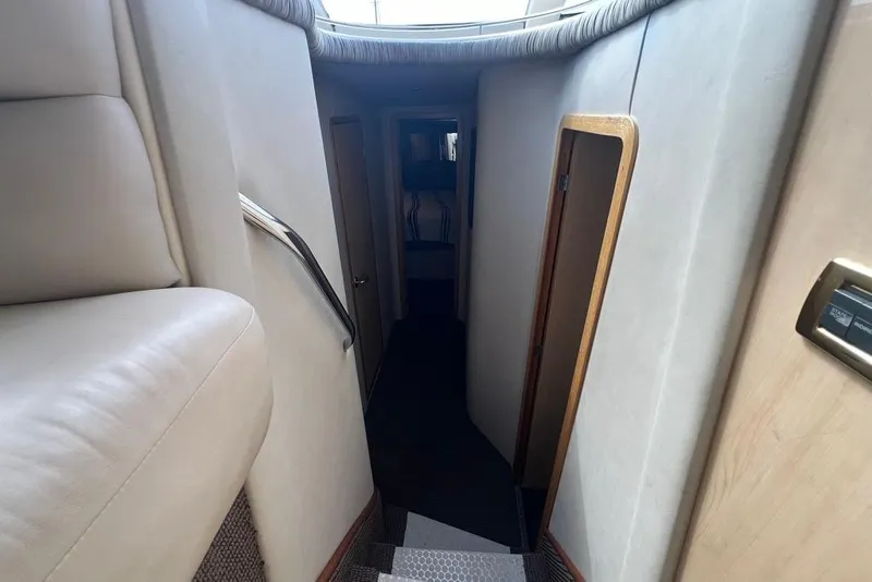 Slide: The Image of Interior hallway of a 2001 Sea Ray 480 Sedan Bridge yacht, featuring plush seating and modern design. - 28