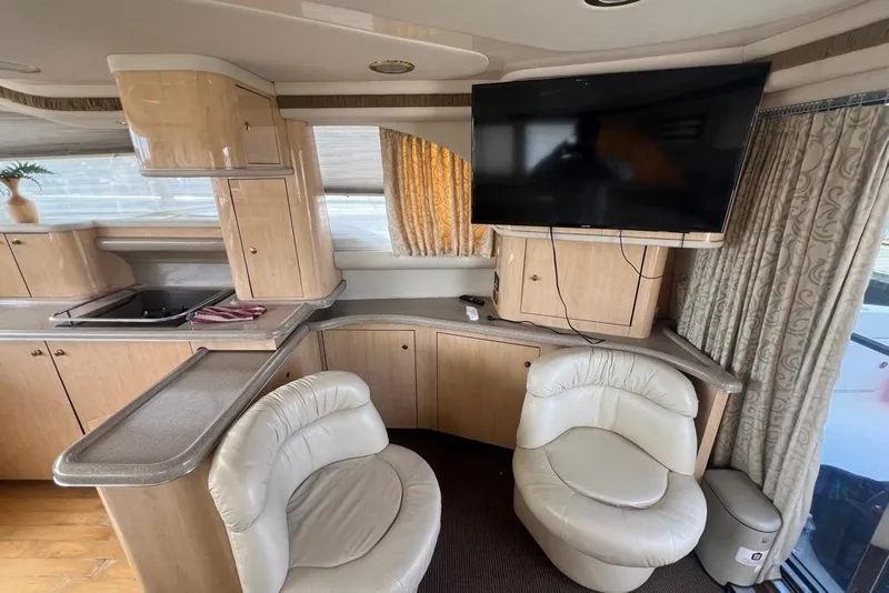 Slide: The Image of Luxurious interior of a 2001 Sea Ray 480 Sedan Bridge with modern amenities. - 29
