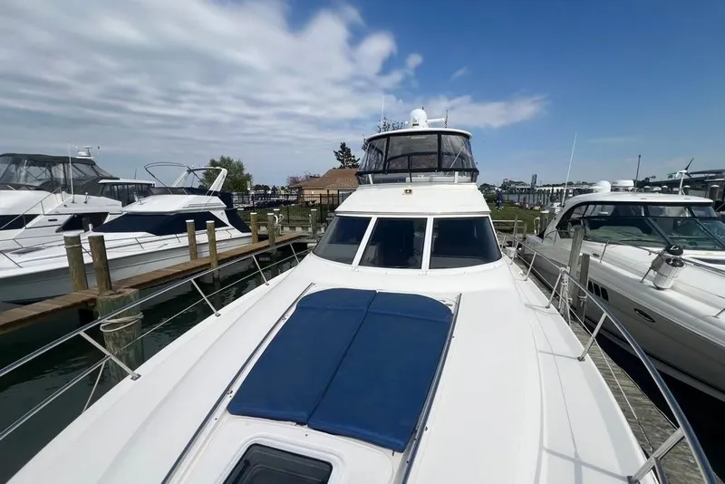 Slide: The Image of 2001 Sea Ray 480 Sedan Bridge yacht docked at marina under blue sky. - 31