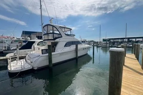 Slide: The Image of 2001 Sea Ray 480 Sedan Bridge yacht docked at marina under clear sky. - 34