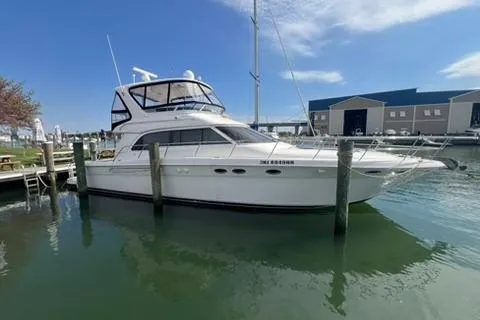 Slide: The Image of 2001 Sea Ray 480 Sedan Bridge yacht docked at marina under clear blue sky. - 35