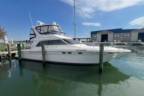 Slide: The Image of 2001 Sea Ray 480 Sedan Bridge yacht docked at marina under clear blue sky. - 36