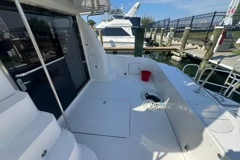Slide: The Image of 2001 Sea Ray 480 Sedan Bridge yacht docked, featuring spacious deck and marina view. - 37