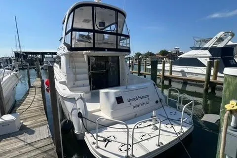 Slide: The Image of 2001 Sea Ray 480 Sedan Bridge docked at a marina under clear blue skies. - 40