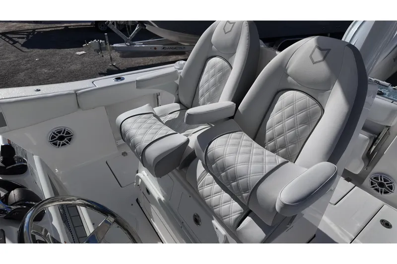 Slide: The Image of Luxury seating on 2026 Sea Fox 288 Commander boat, featuring quilted upholstery and armrests. - 13
