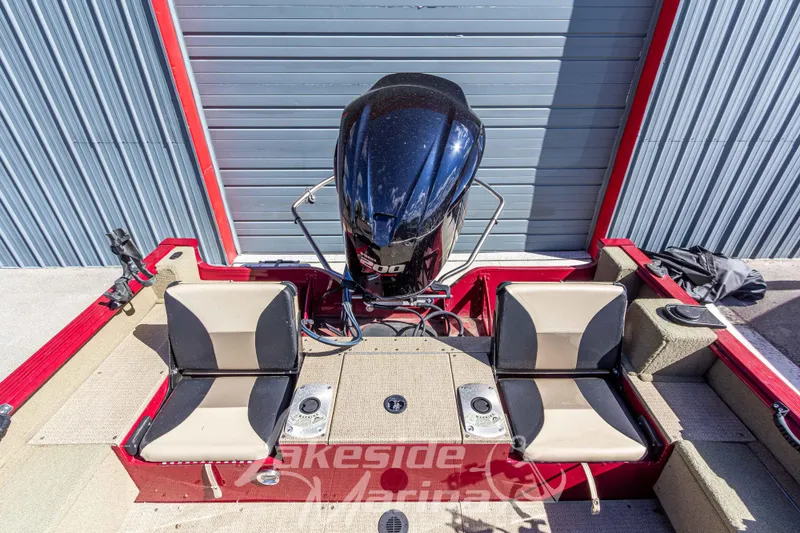 Slide: The Image of 2020 G3 Angler V19 FS boat interior with dual seats and motor, in a marina setting. - 11