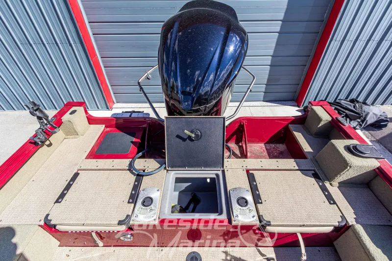 Slide: The Image of 2020 G3 Angler V19 FS boat interior with open storage compartment and motor. - 13