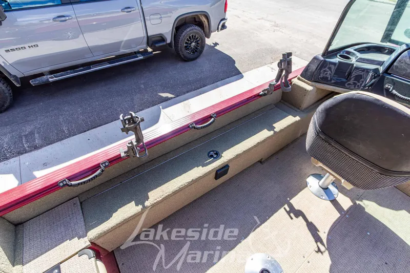 Slide: The Image of 2020 G3 Angler V19 FS boat interior with rod holders and seating, parked beside a truck. - 14