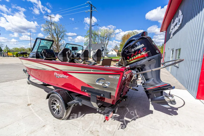 Slide: The Image of 2020 G3 Angler V19 FS boat with Yamaha motor, parked outdoors on a sunny day. - 3