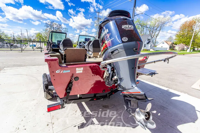 Slide: The Image of 2020 G3 Angler V19 FS boat with Yamaha 200 engine, parked outdoors. - 4