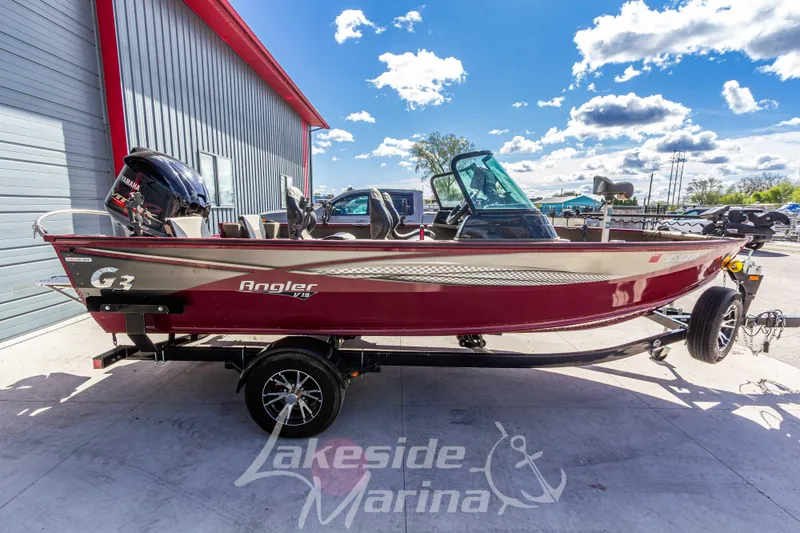 Slide: The Image of 2020 G3 Angler V19 FS boat on trailer at Lakeside Marina, under a bright blue sky. - 8