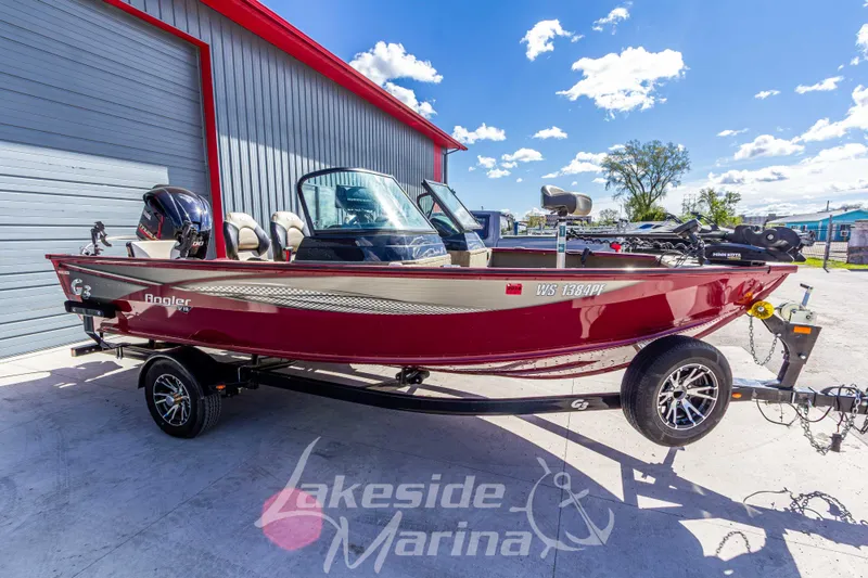 Slide: The Image of 2020 G3 Angler V19 FS boat in red, parked at Lakeside Marina under a clear blue sky. - 9