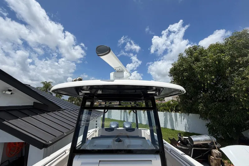 Slide: The Image of 2017 Robalo R302 Center Console boat under a clear blue sky. - 10