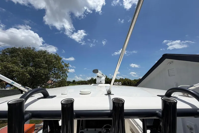 Slide: The Image of 2017 Robalo R302 Center Console boat roof under blue sky with clouds. - 15