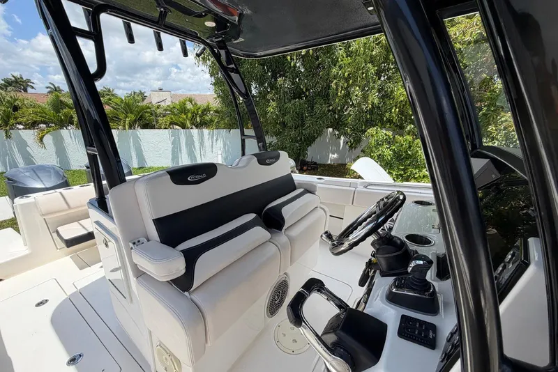 Slide: The Image of 2017 Robalo R302 Center Console boat interior with steering wheel and seating. - 17