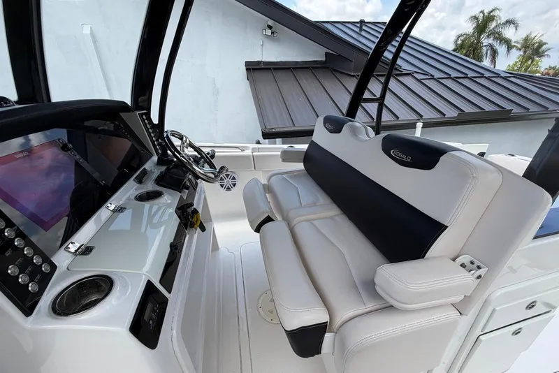 Slide: The Image of 2017 Robalo R302 Center Console boat interior with steering wheel and seating. - 18