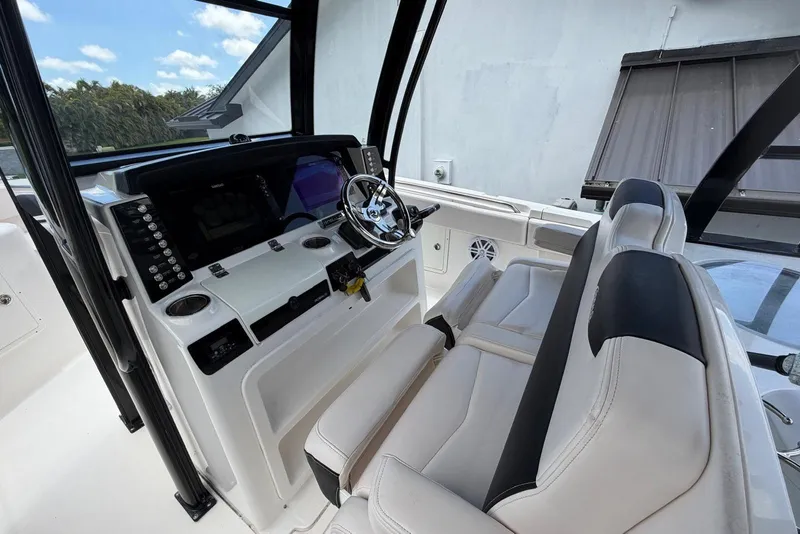 Slide: The Image of 2017 Robalo R302 Center Console boat interior with dual seats and modern dashboard. - 22